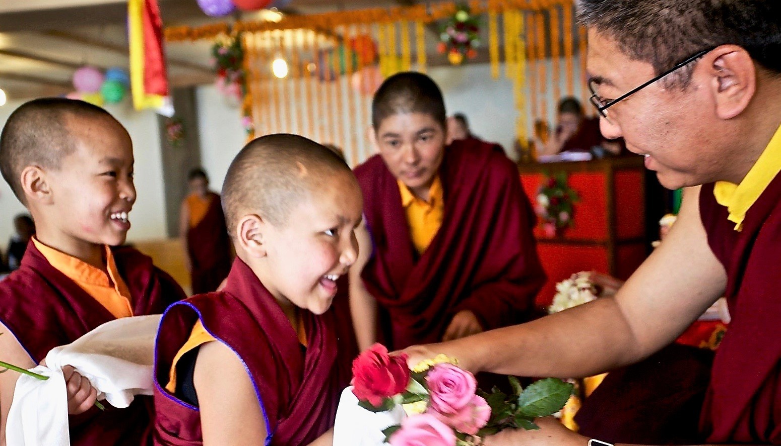 Young Nun giving Rinpoche roses on his birthday 2019 2